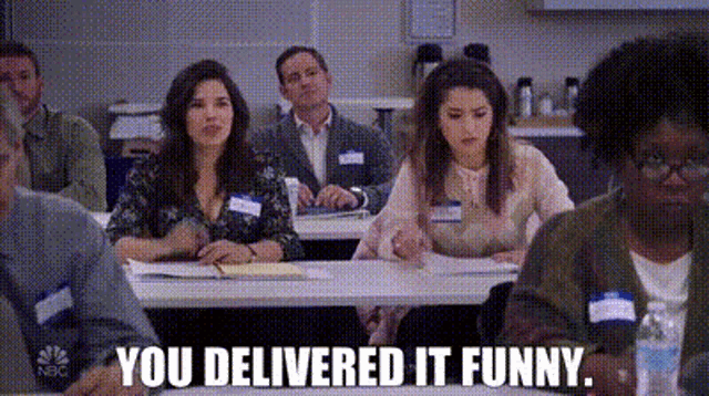 a group of people are sitting at tables in a classroom and one of them is saying `` you delivered it funny '' .