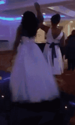a girl in a white dress with a blue sash is dancing