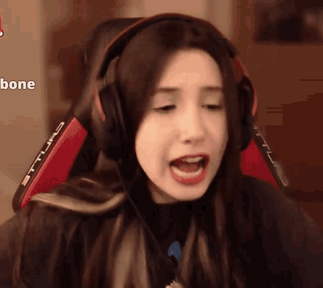 a woman wearing headphones is sitting in a chair that says bone