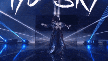 a woman is dancing in front of a sign that says ayo sky