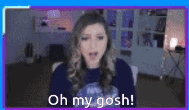 a woman in a blue sweater is talking on a video call .