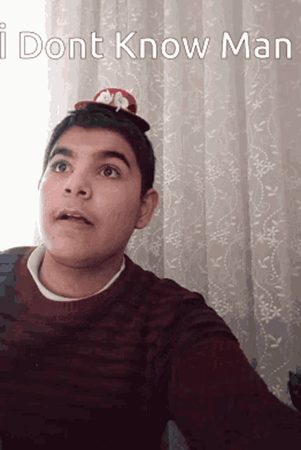 a young man with a hat on his head and the words i dont know man below him