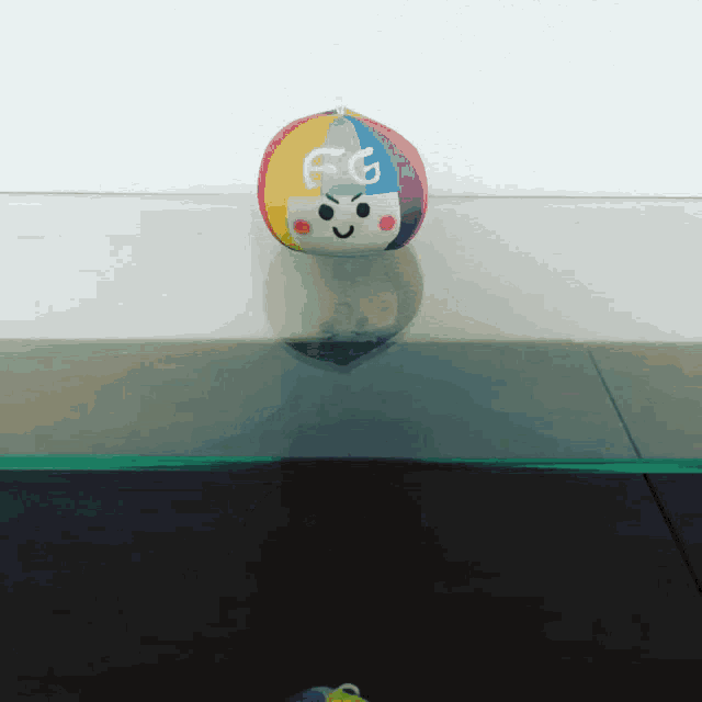 a colorful ball with a face and the letter e on it