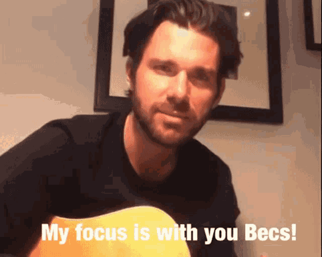 a man playing a guitar with the words " my focus is with you becs " below him