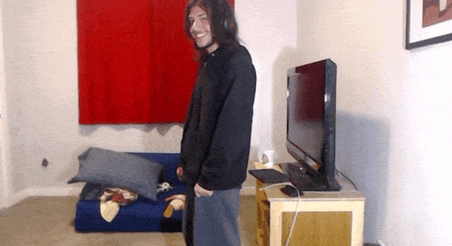 a man standing in front of a flat screen tv