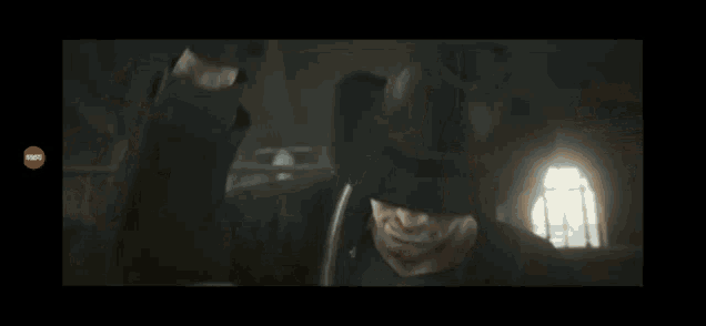 a man in a cowboy hat is holding a bottle of liquor