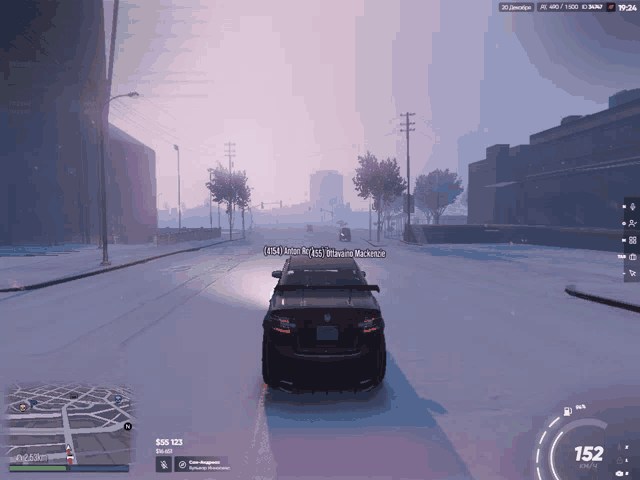 a car is driving down a snowy street with a message on the screen that says ' sss 123 ' on the top