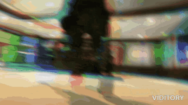 a blurred image of a person walking with the word viditary in the bottom right corner