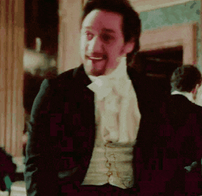 a man in a tuxedo and bow tie is smiling .