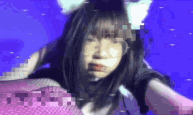 a blurry picture of a girl wearing cat ears and a pink top .