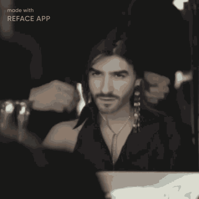 a black and white photo of a man with a beard and earrings is made with reface app