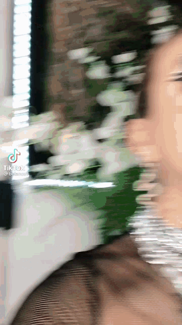 a blurry picture of a woman 's face with a tiktok logo on it