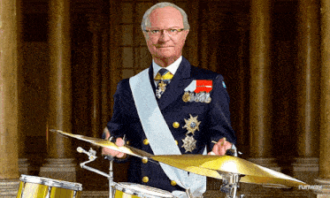 a man in a military uniform is holding a cymbal and playing drums