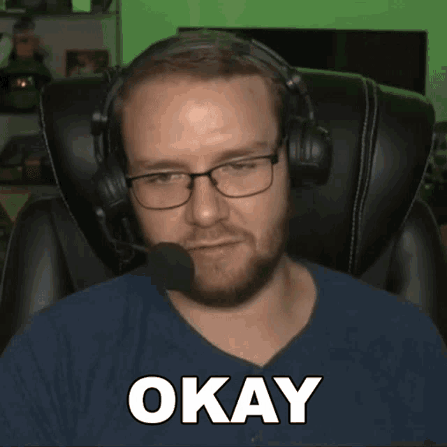 a man wearing glasses and headphones says " okay "