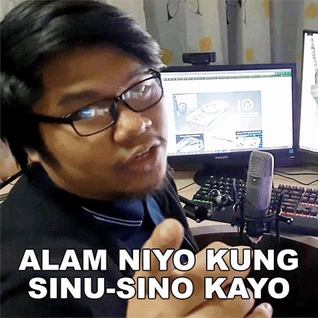 a man sitting in front of a computer with the words alam niyo kung sinu-sino kayo on the bottom