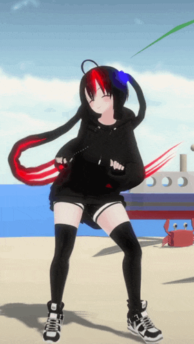 a girl in a black hoodie and black shorts stands on a beach