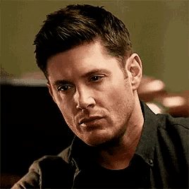 a close up of a man 's face with a serious expression .