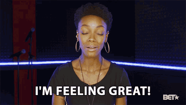 a woman says i 'm feeling great in front of a microphone