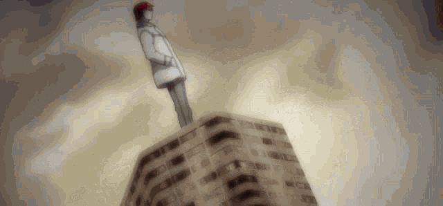 a person standing on top of a building with a red hat on