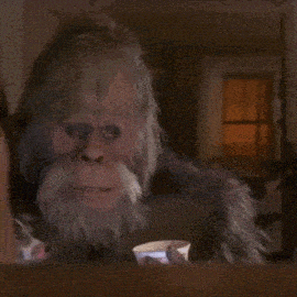 a bigfoot is holding a bowl of yogurt in his hands