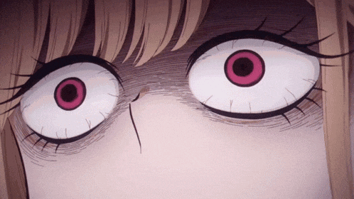 a close up of a cartoon character 's eyes with a very angry look on their face .