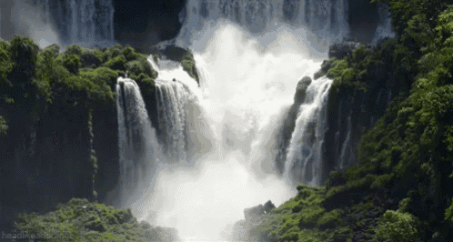 a waterfall is surrounded by trees and a headline that says headlinesmash