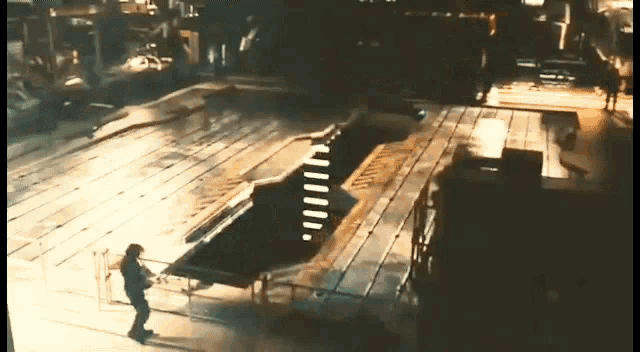 a man is standing in front of a conveyor belt that says ' a ' on it