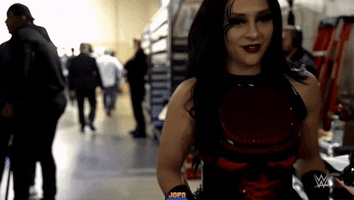 a woman in a red and black outfit with a w on her arm
