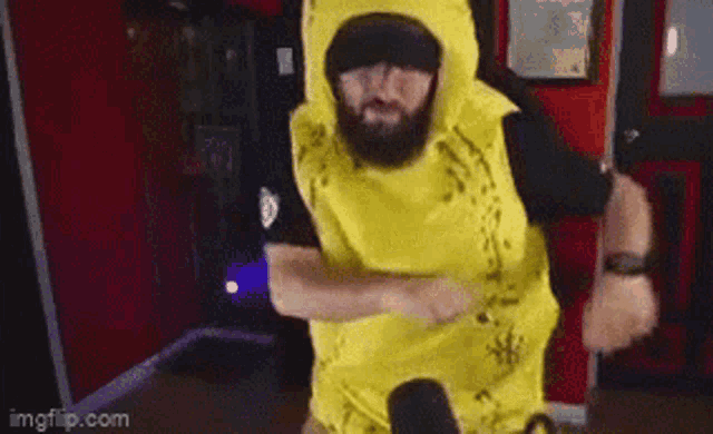 a man with a beard is dancing in a yellow banana costume