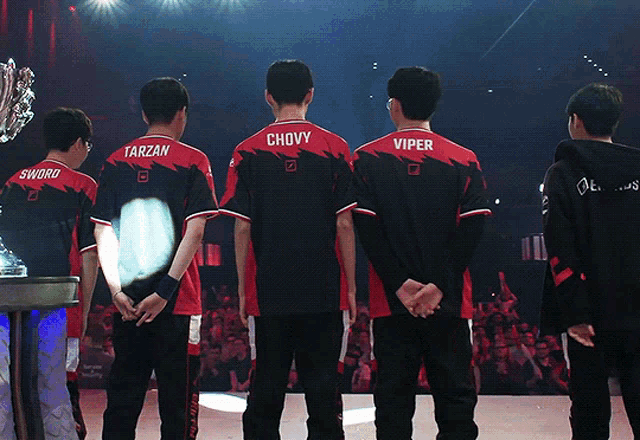 tarzan chovy viper and sword are standing on a stage