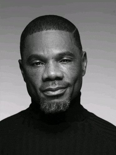 a black and white photo of a man with a turtleneck