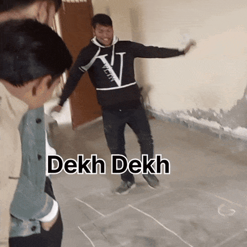 a group of people standing around a man with the words dekh dekh written on the floor