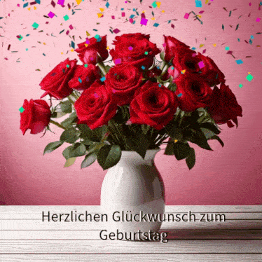 a bouquet of red roses in a white vase with the words herzlichen glückwunsch zum geburtstag below