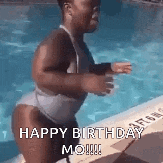 a woman in a bathing suit is jumping into a swimming pool to celebrate her birthday .