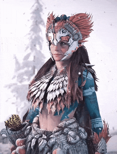 a woman in a feathered costume holds a pine cone in her hands