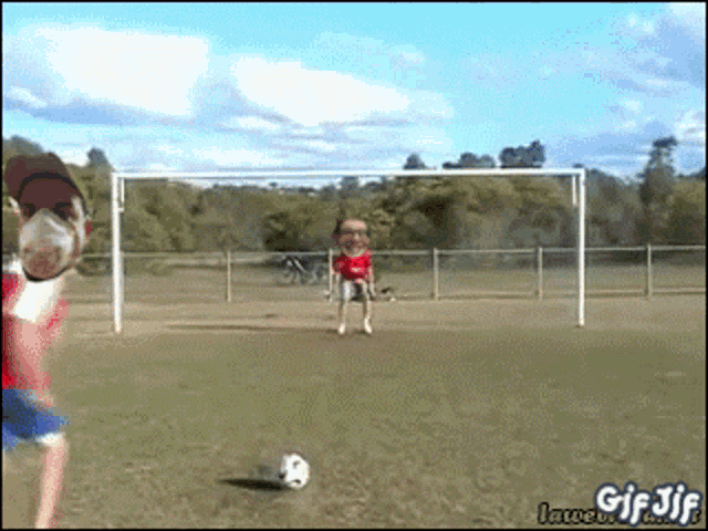 a gif of a man wearing a mask kicking a soccer ball in front of a soccer goal