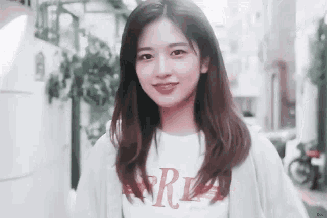 a young woman wearing a white t-shirt with the word ralph lauren on it .