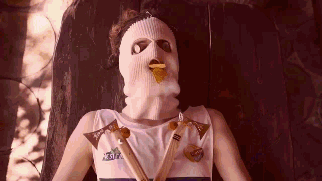 a man wearing a ski mask and a shirt that says nestea