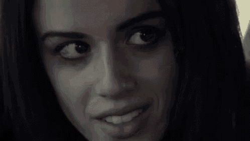 a close up of a woman 's face with her eyes closed