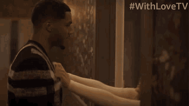 a man is touching a woman 's leg with the hashtag #withlovetv above him