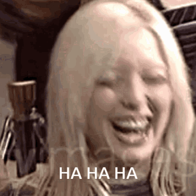 a close up of a woman laughing with the words ha ha ha written on the bottom