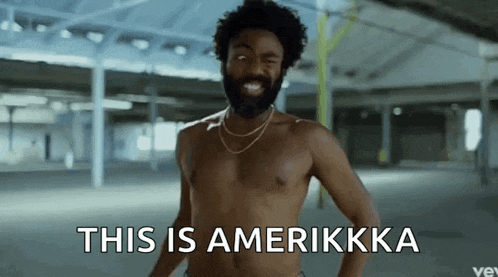 a shirtless man with a beard and a necklace says this is amerikkka