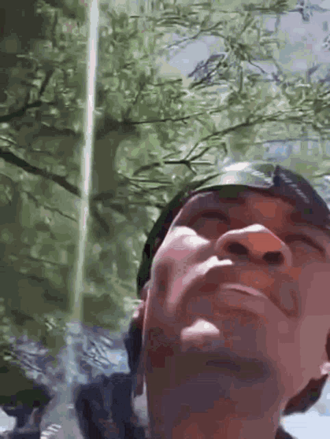 a close up of a man 's face looking up at the sky
