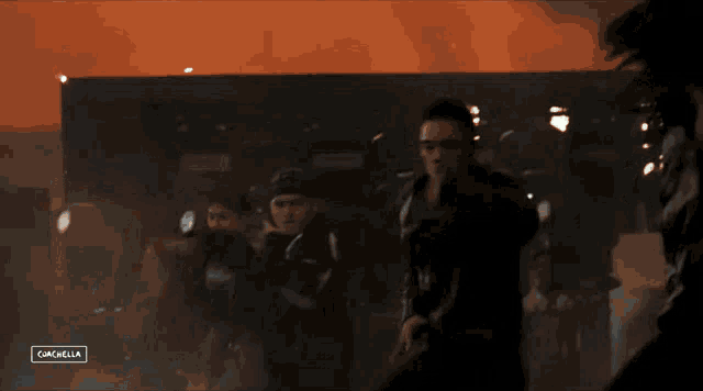 a group of people are dancing in front of a screen that says campbella
