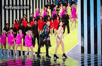 a man and a woman are dancing on a stage in front of a crowd .