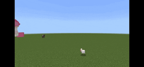 a white sheep is standing in a grassy field with a pink house in the background