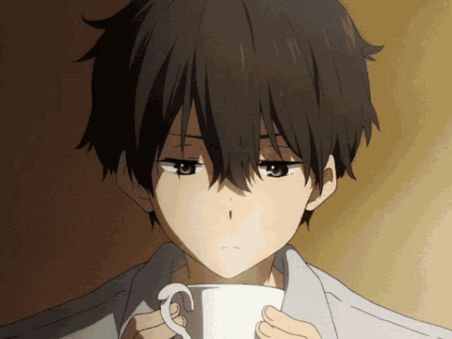 a close up of a boy holding a white cup