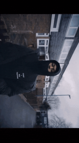 a person wearing a black hoodie that says ' i am anonymous ' on the front