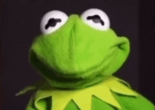 kermit the frog from the muppet show is making a funny face and smiling .