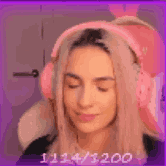 a woman wearing pink headphones with the number 111411200